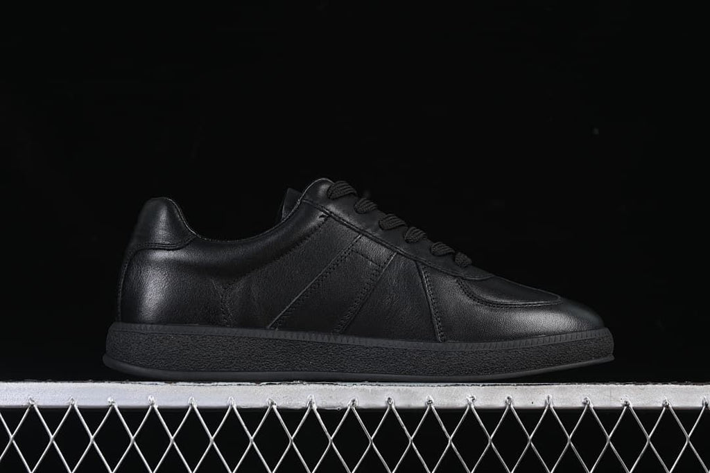 Side profile of a black low-top sneaker