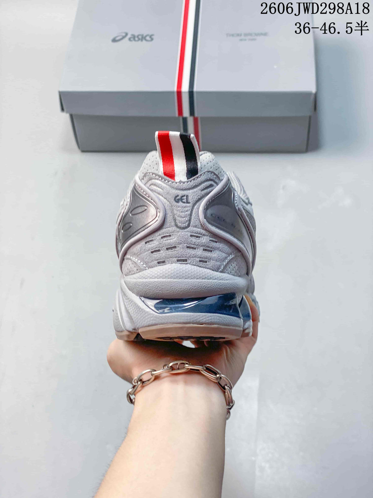 Rear view of the sneaker with a striped heel pull tab and GEL lettering.