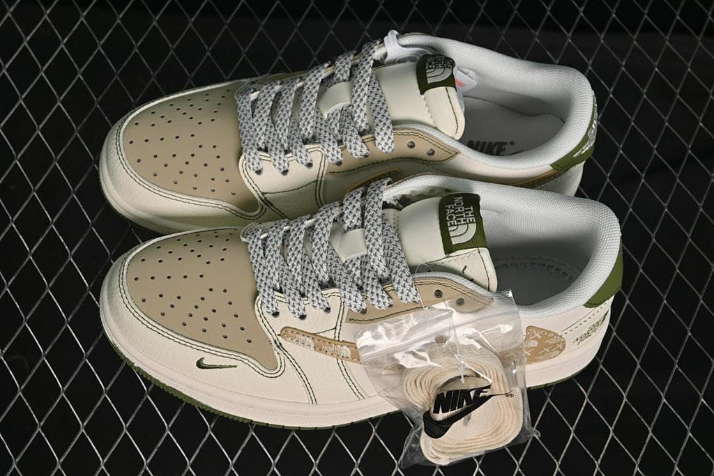 Top view of a pair of cream, beige and olive-green low-top sneakers with patterned laces and an extra lace set