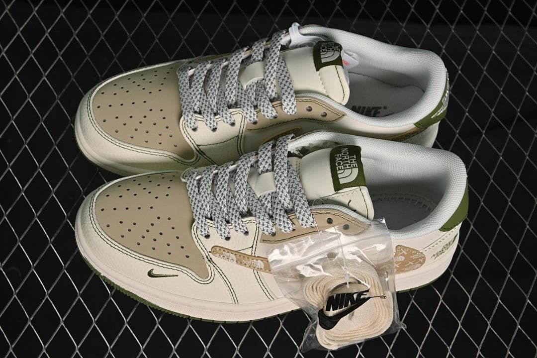 Top view of a pair of cream, beige and olive-green low-top sneakers with patterned laces and an extra lace set