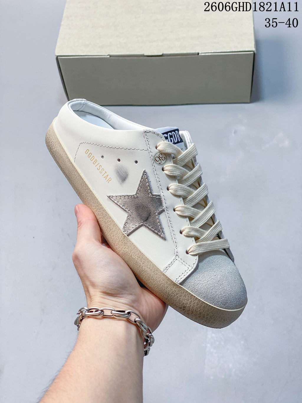 Close side view of the sneaker with silver star appliqué, gray toe panel, and visible scuff-style marks