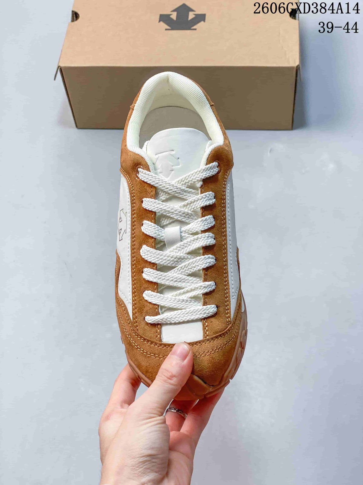 Top view of the lace-up front of a brown and white Descente sneaker