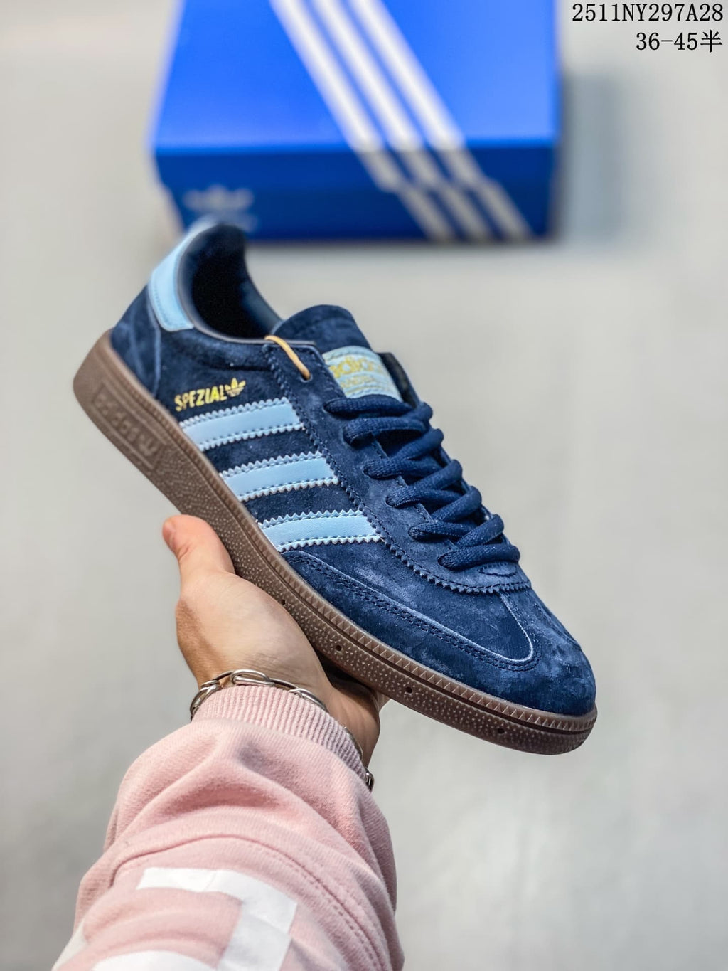 Navy Adidas Spezial-style sneaker with pale blue stripes and brown outsole