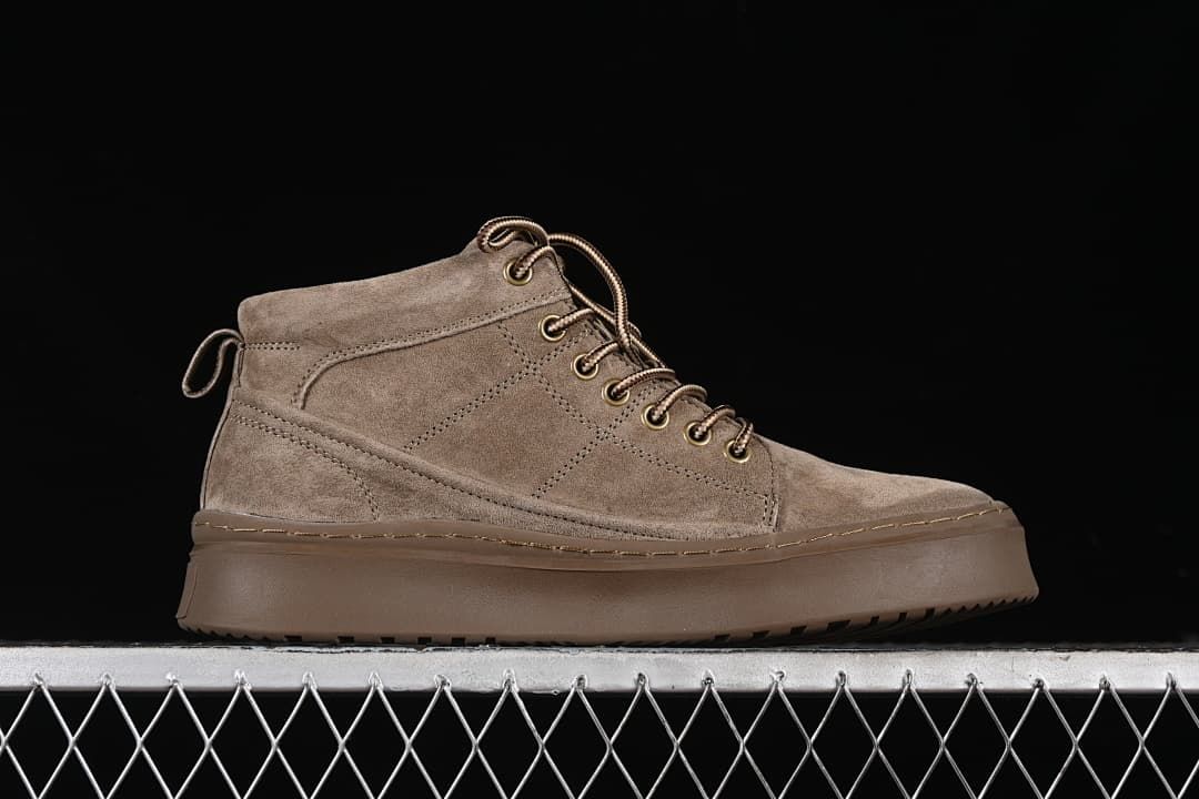 Side profile of a khaki mid-top lace-up boot