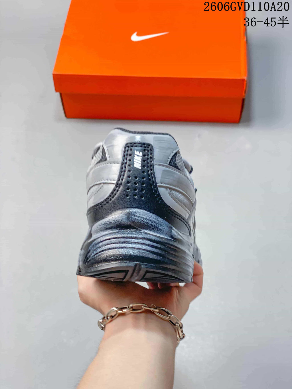 Rear view of the silver and gray sneaker showing the heel panel and collar.