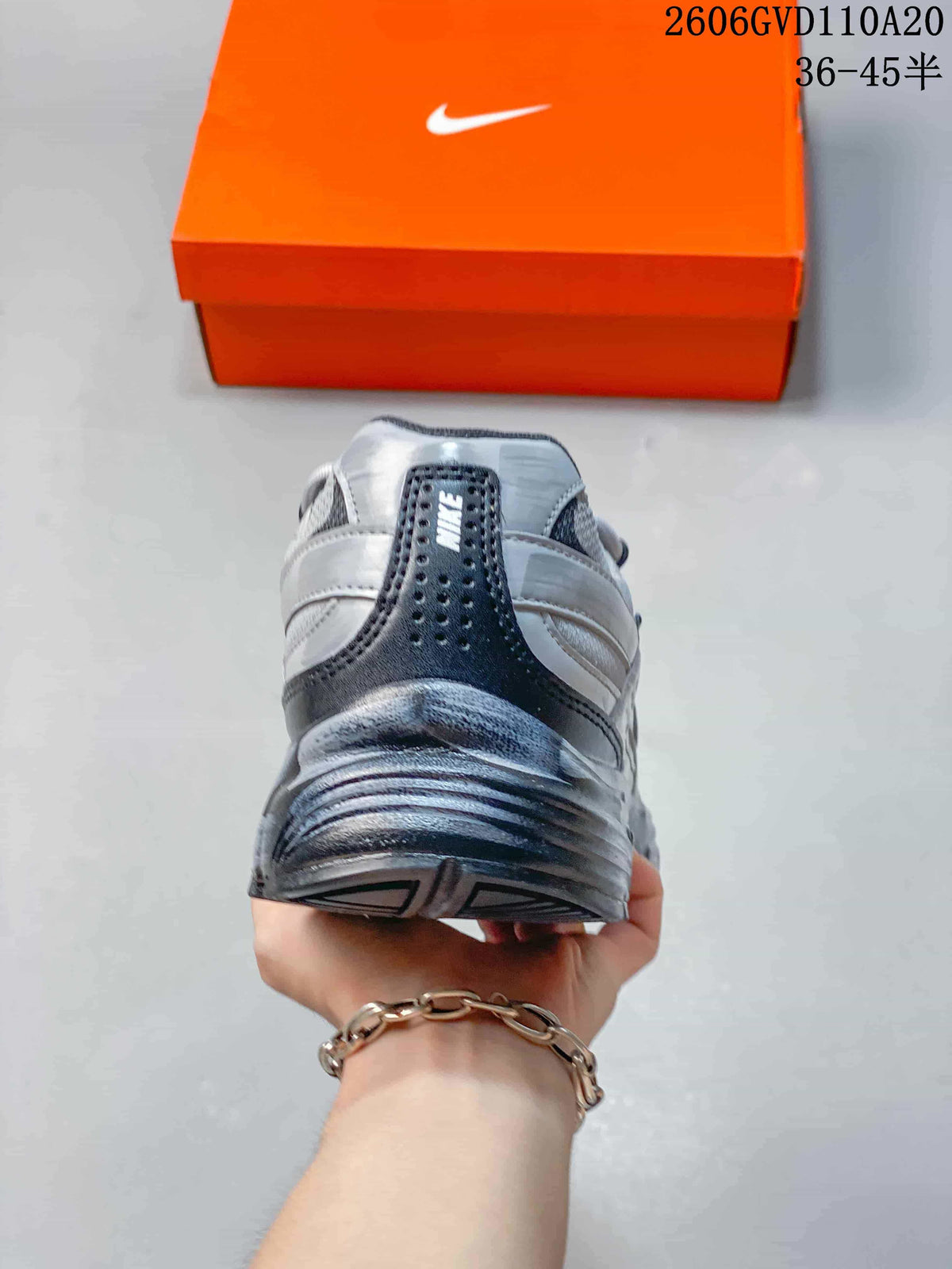 Rear view of the silver and gray sneaker showing the heel panel and collar.