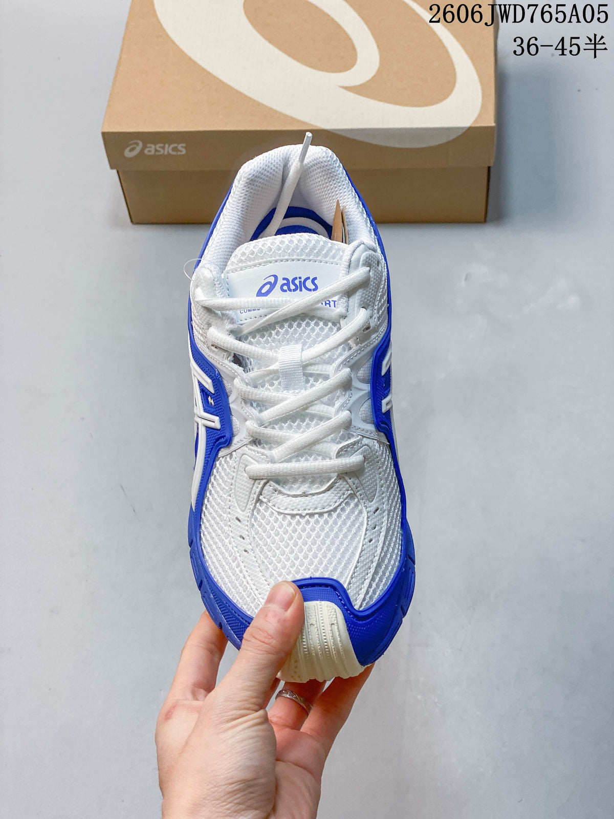 Front view of a white and blue lace-up sneaker.