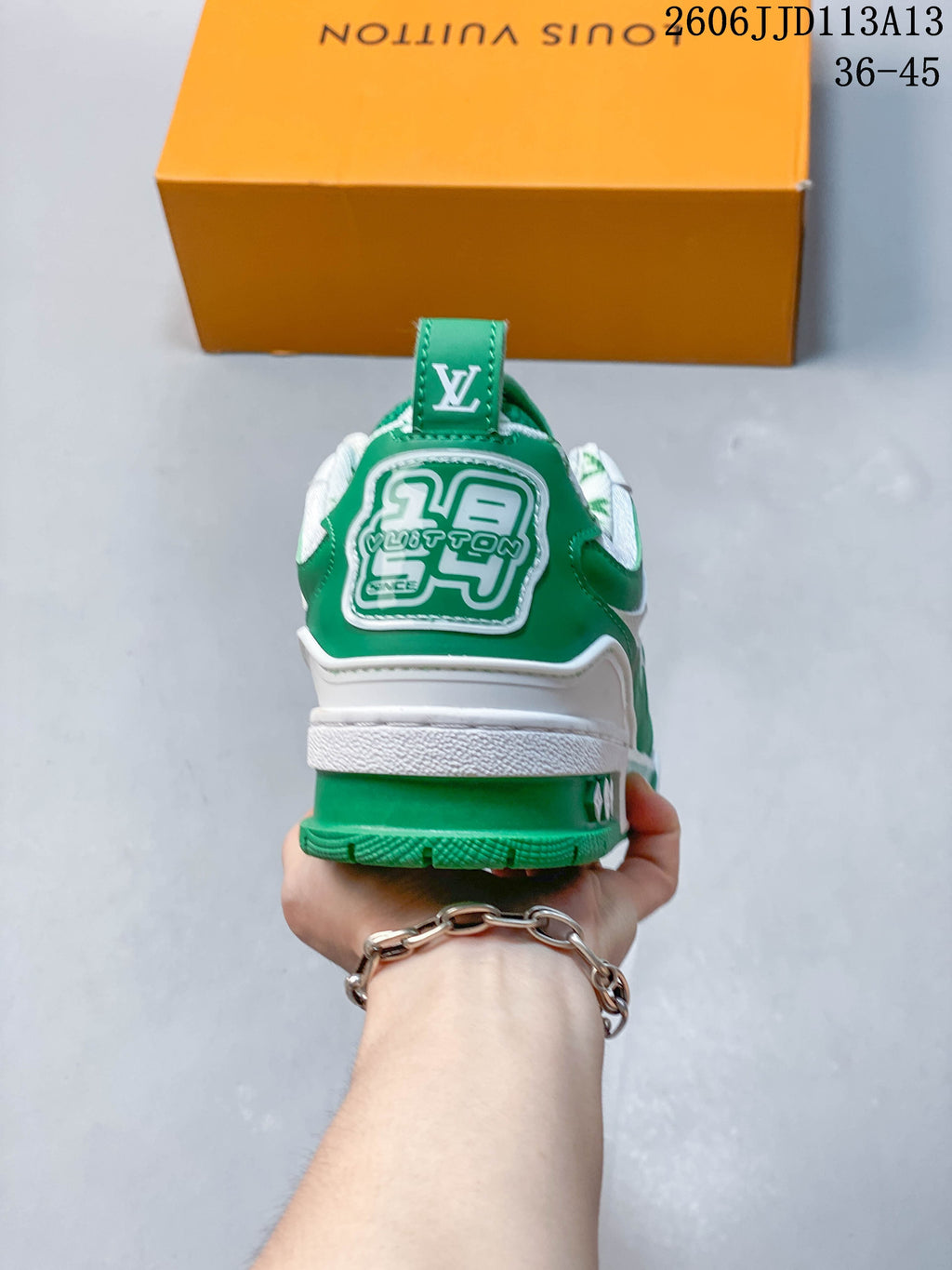 Rear view showing the green heel panel and white midsole.