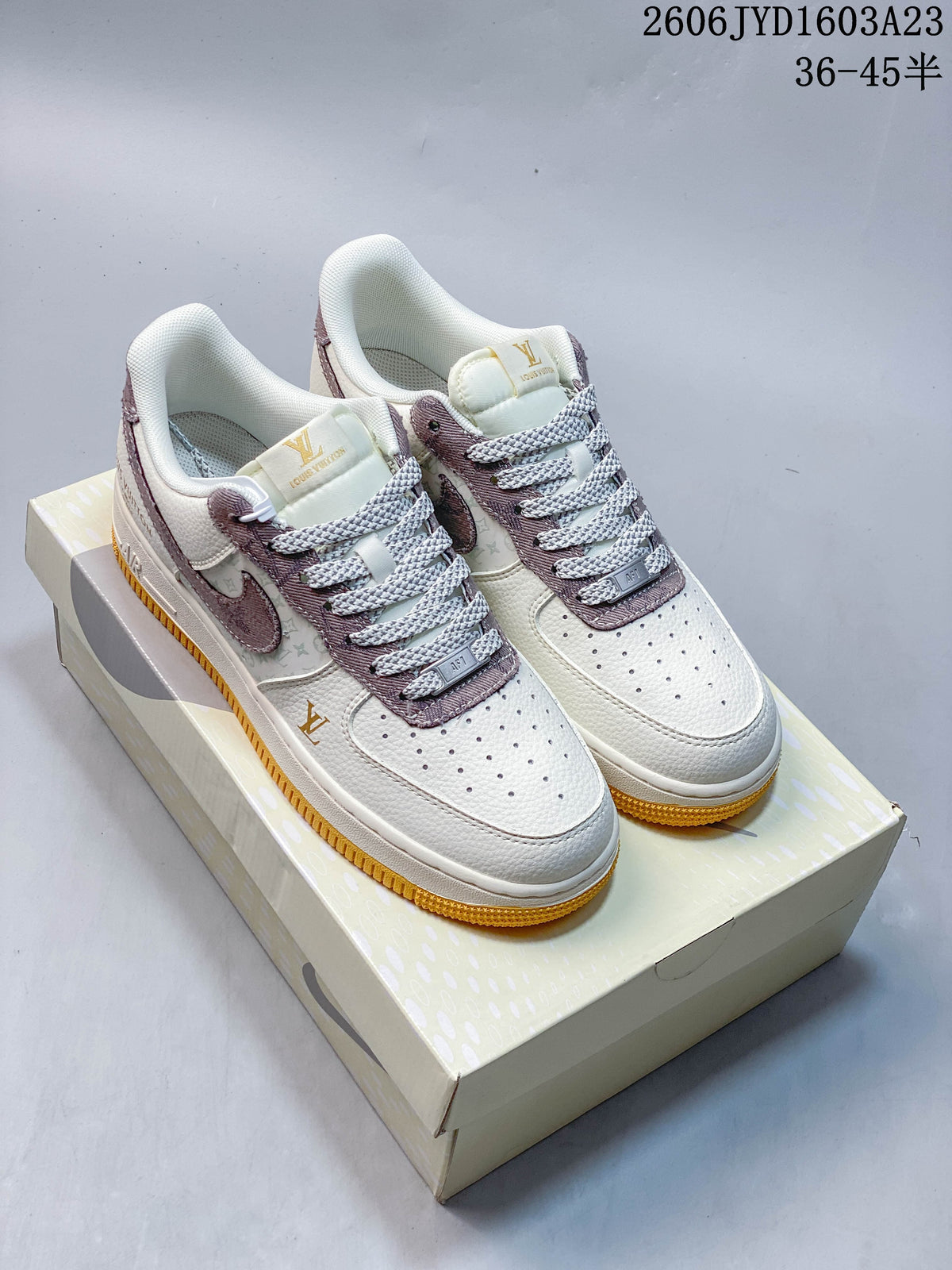 Pair of cream and mauve low-top sneakers with patterned side panels and golden gum-colored soles