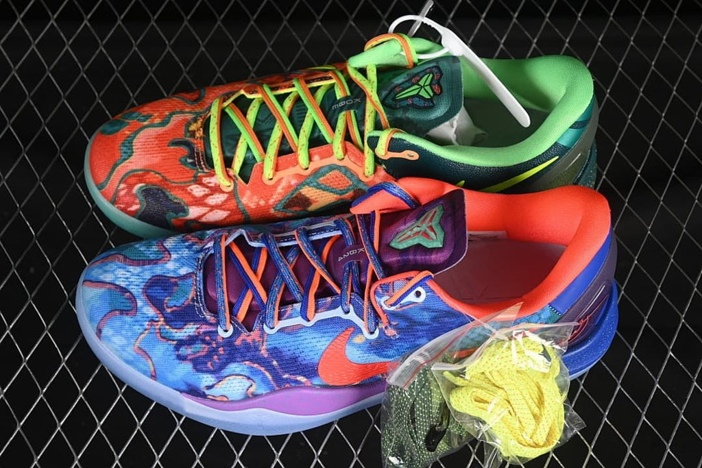 Blue and green multicolor basketball shoes shown together with spare laces
