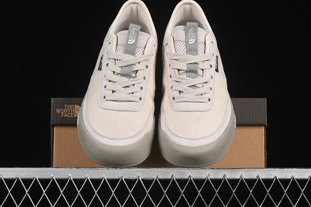Front view of both sneakers displayed on the shoebox