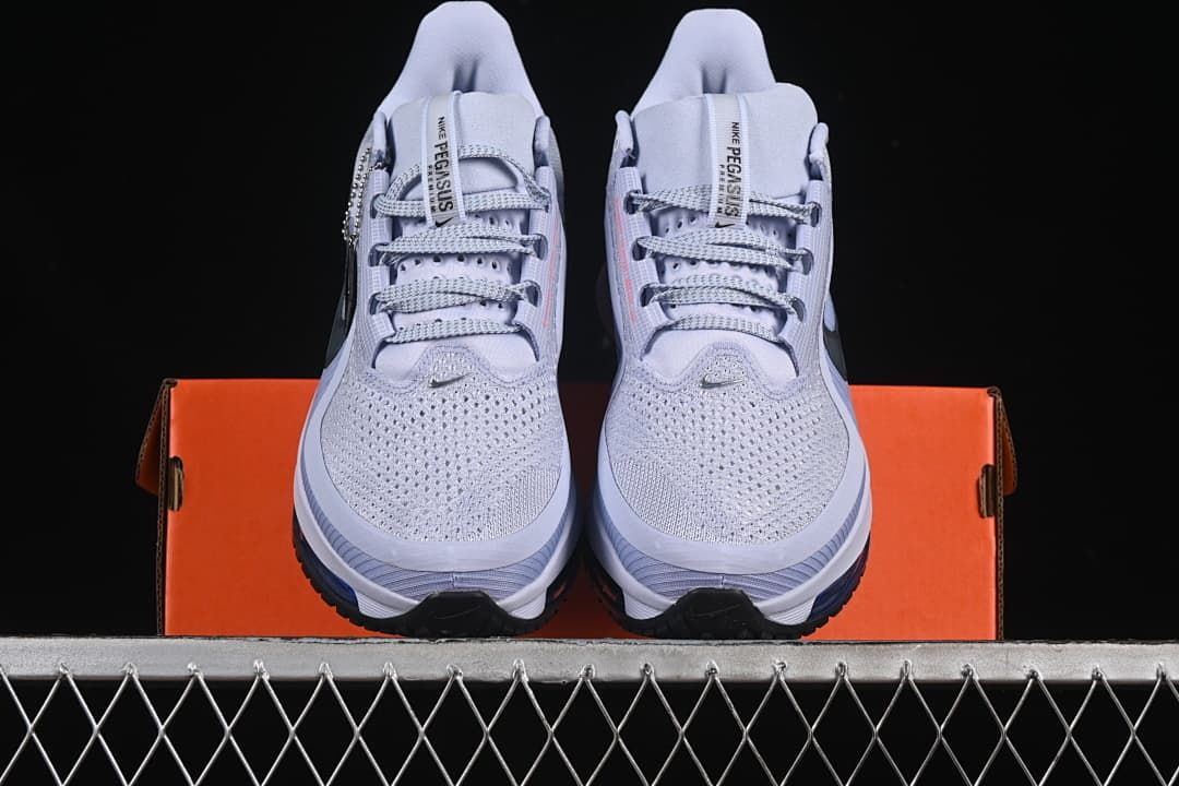 Front view of the pair resting on an orange shoe box