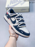 Navy and cream low-top sneaker with thick white laces, shown beside a Nike Dunk box.