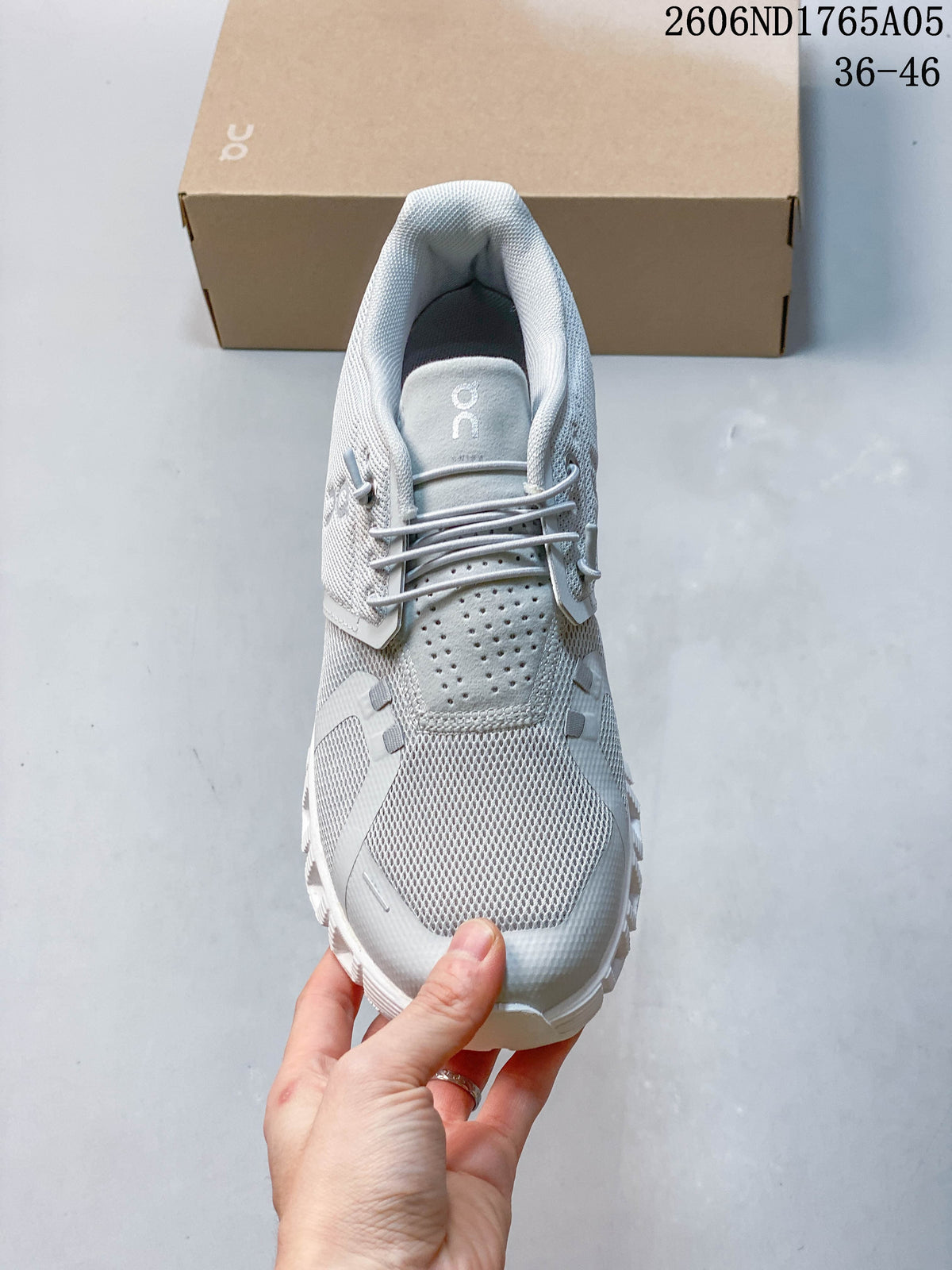 Top view of the elastic lacing and perforated tongue on an On Cloud 5 sneaker