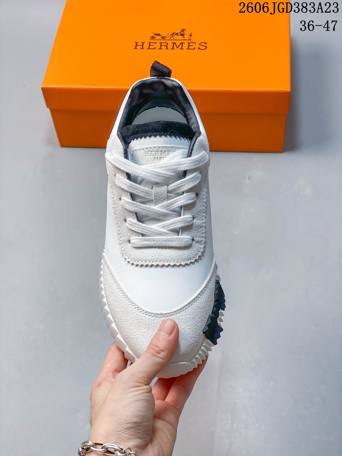 Front view showing white laces, textured panels, and black collar lining
