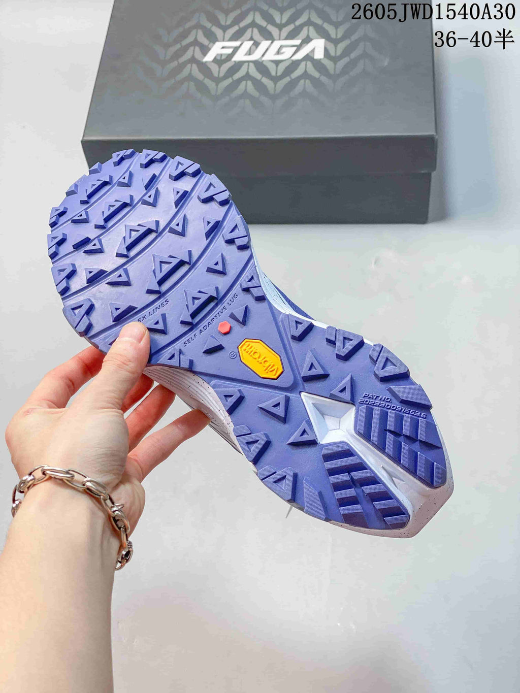 Close-up of the purple lugged outsole with a visible Vibram badge.