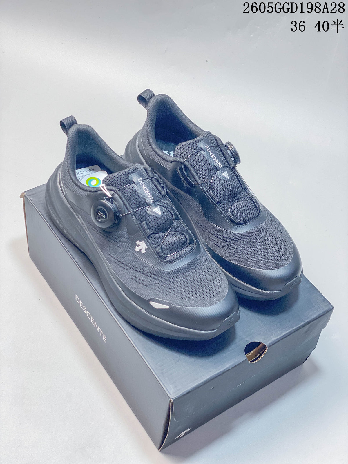 Pair of gray DESCENTE BOA running shoes on a DESCENTE box