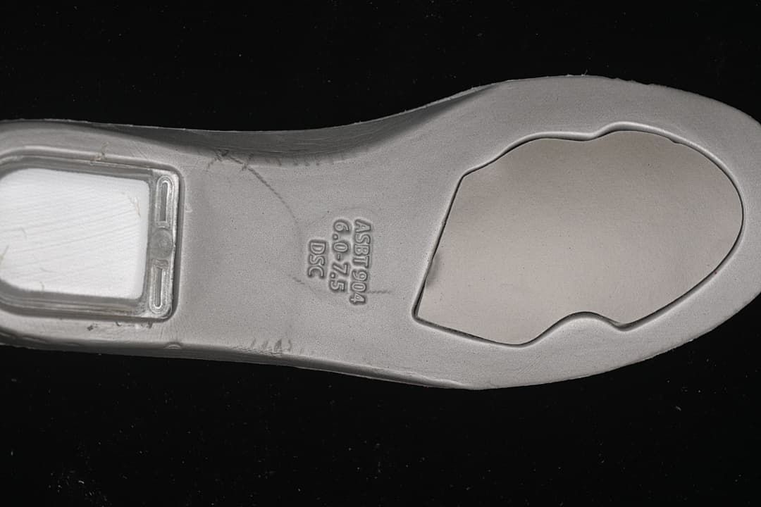Close-up of the shoe insole underside with molded lettering