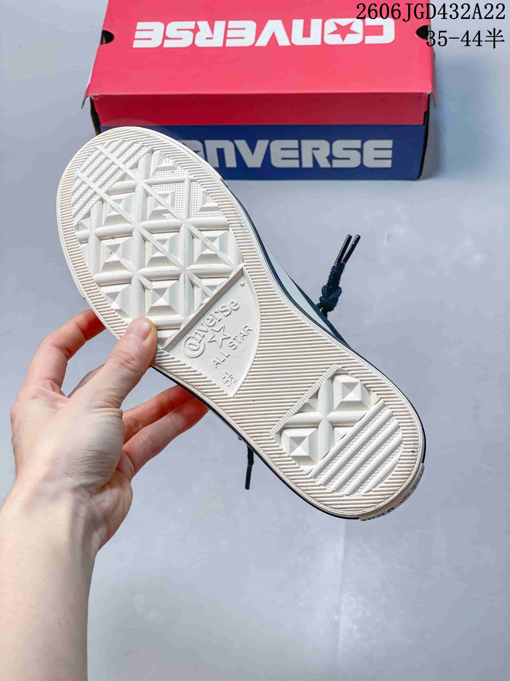 Underside of a Converse sneaker showing the patterned off-white outsole.