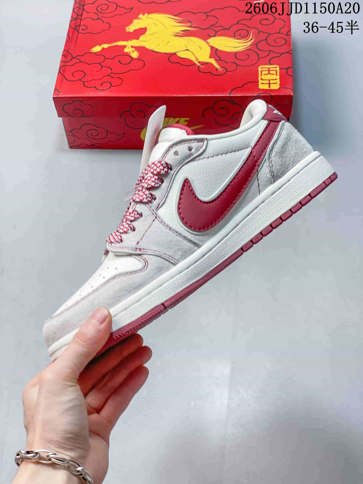 Side view of the white and red low-top sneaker