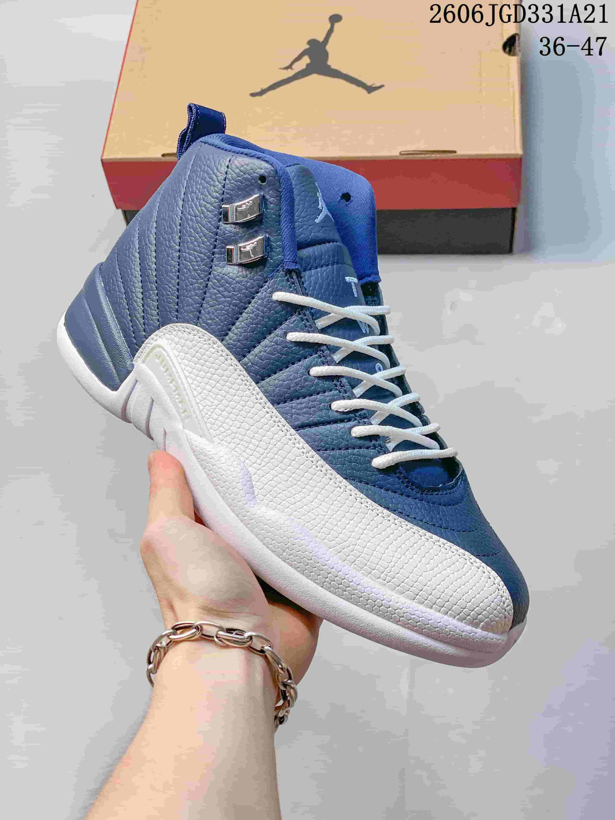 Close-up of a blue and white high-top Air Jordan 12 shoe showing textured panels and lace hardware