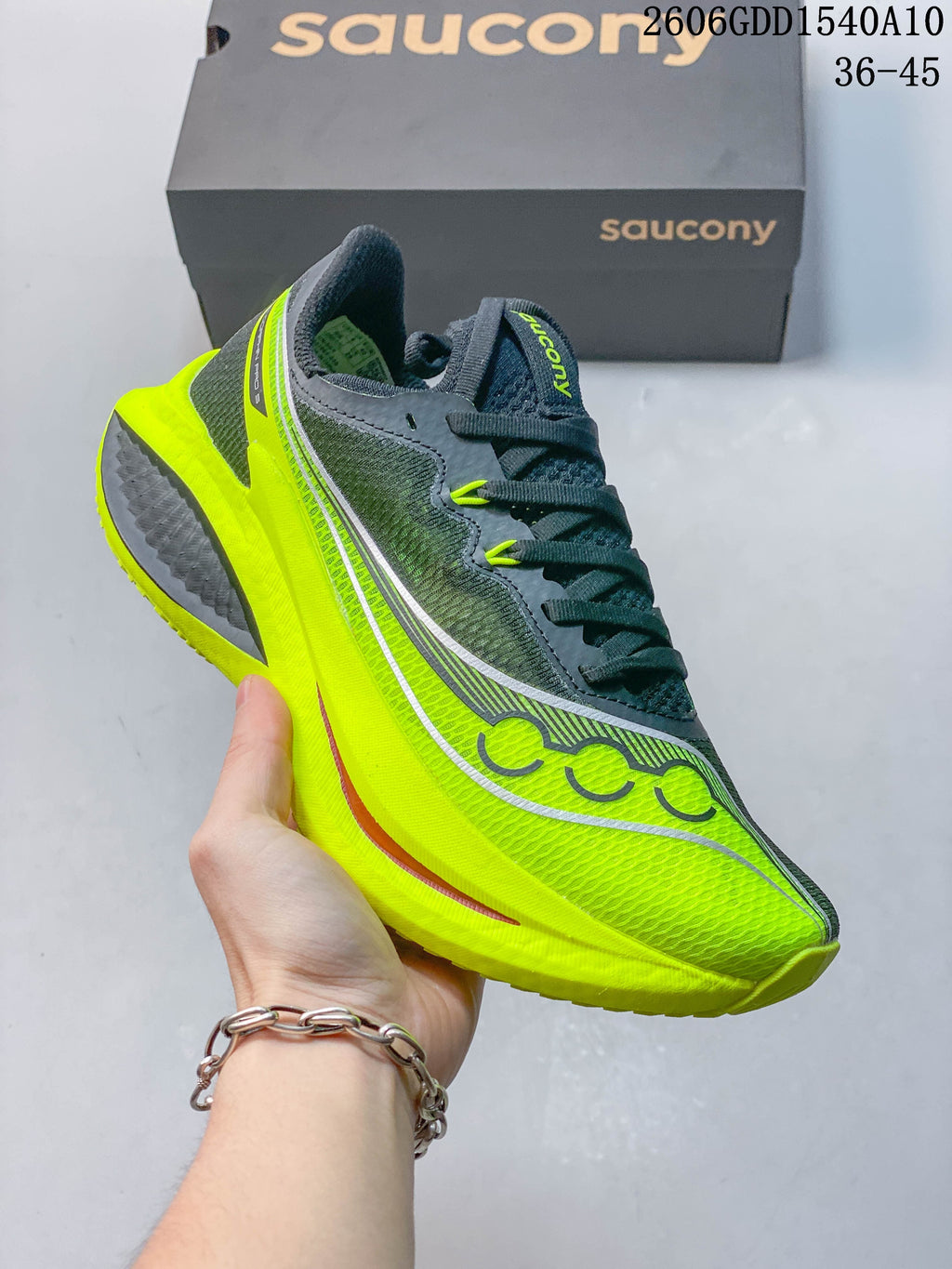 Side profile of the charcoal and neon yellow Saucony Endorphin Pro 5 running shoe.