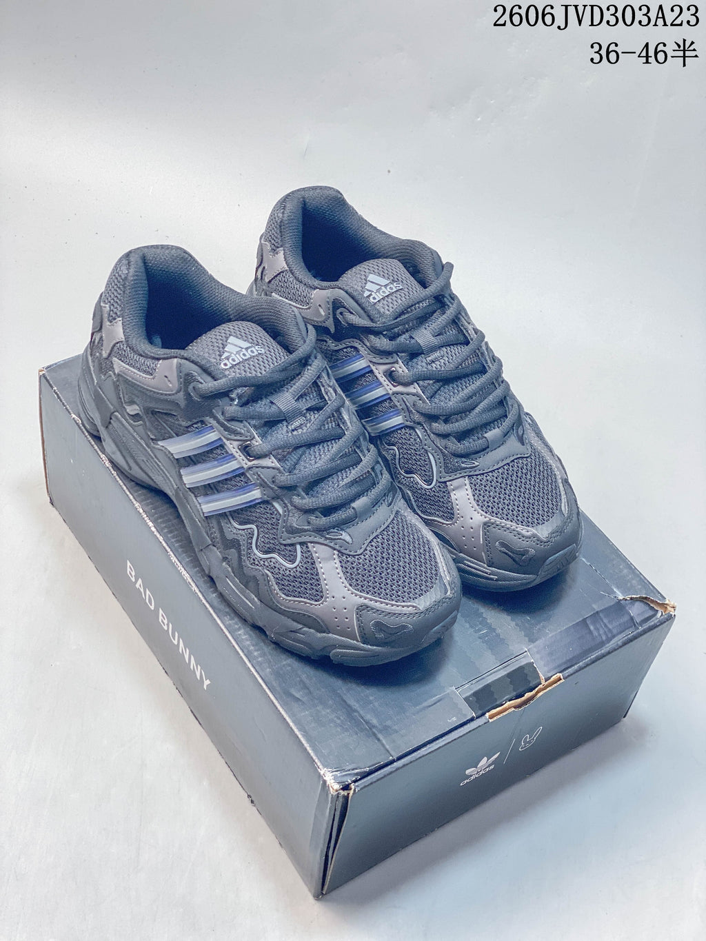 Charcoal gray adidas Response CL sneakers displayed on a Bad Bunny-branded box