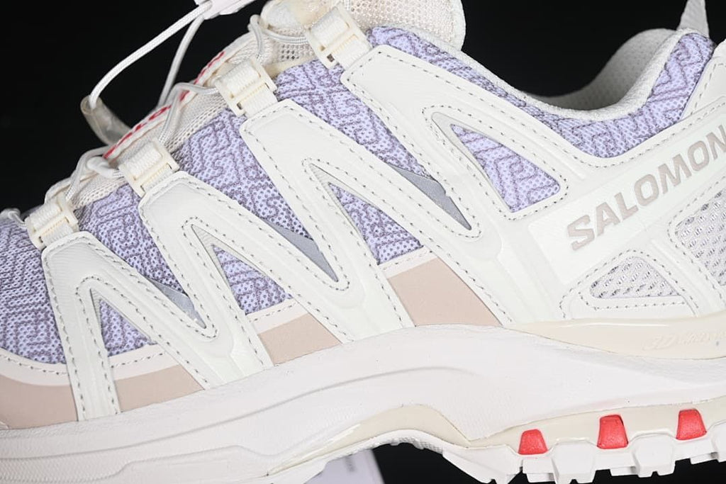 Close-up of the side overlays, lavender patterned upper, and outsole accents.
