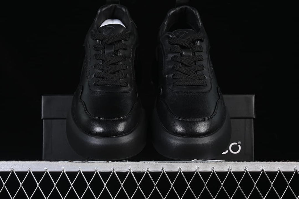 Front view of the pair of black lace-up sneakers