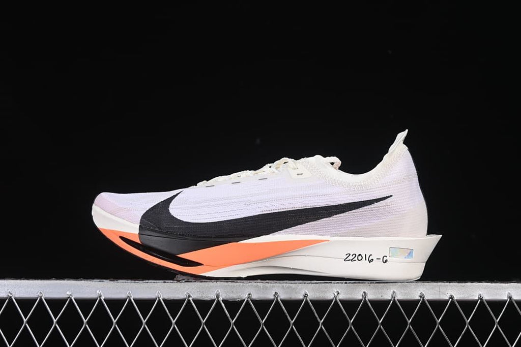 Side view of a white Nike ZoomX Streakfly 2 Pro running shoe with black and orange accents.