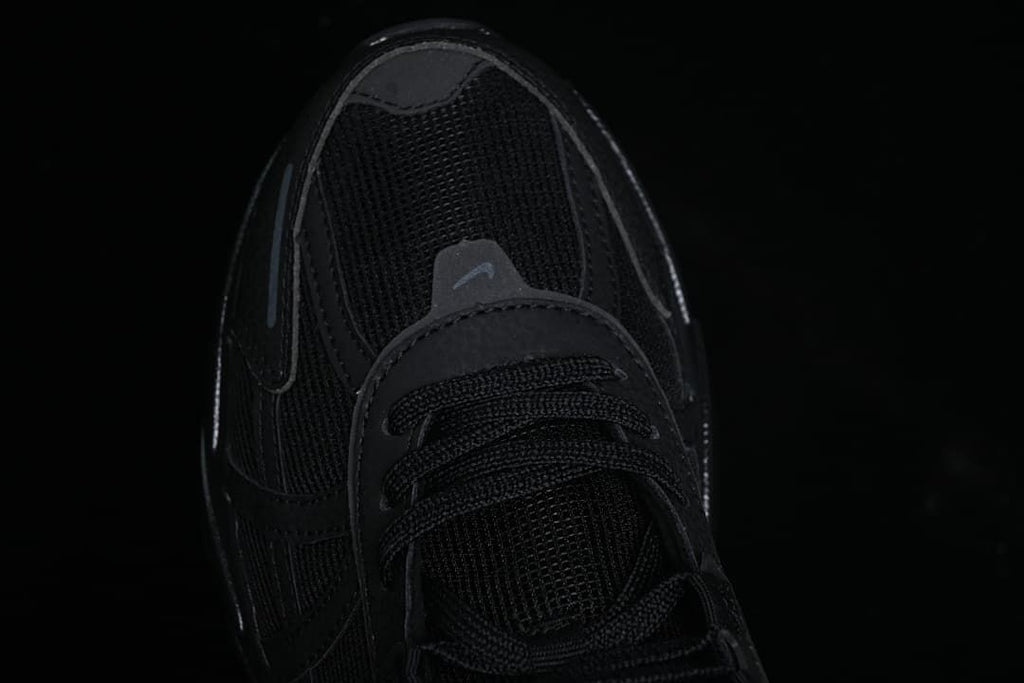 Top-down close-up of the black mesh toe and laces