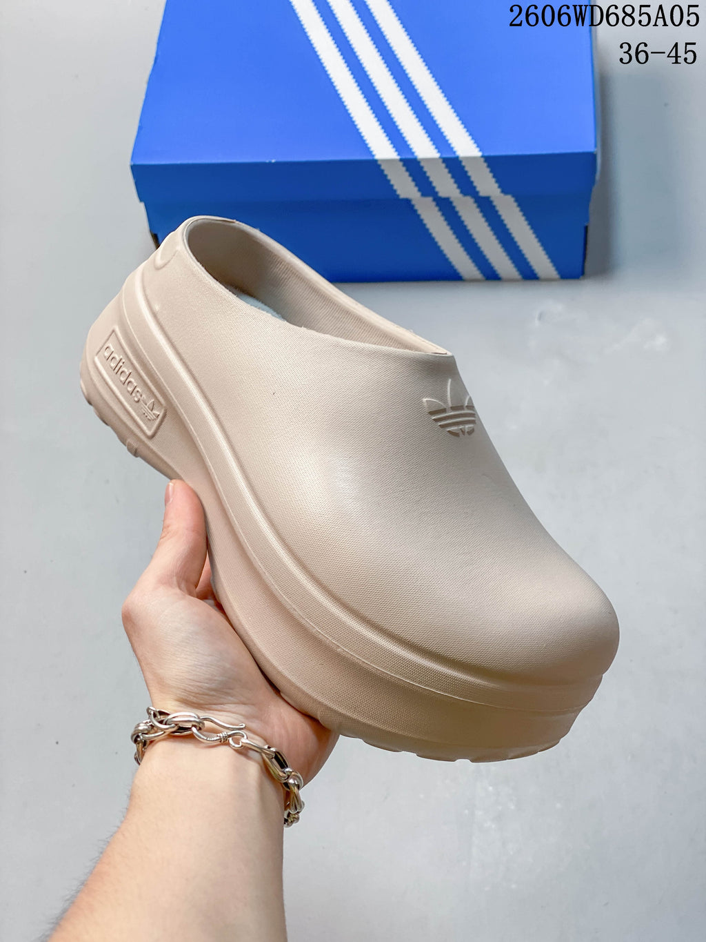 Angled side view of a light beige adidas AdiFOM Stan Smith Mule clog.
