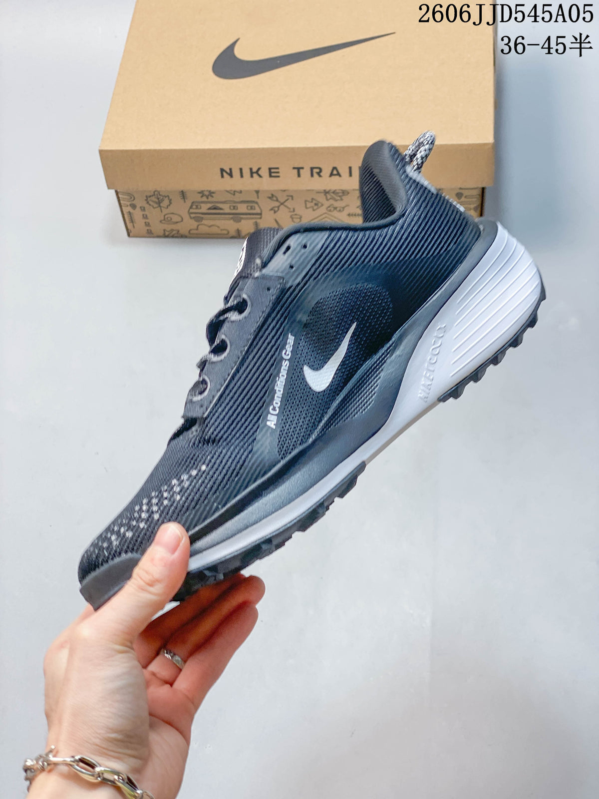 Side profile of a dark gray Nike Pegasus Trail 6 shoe with white Swoosh detail.