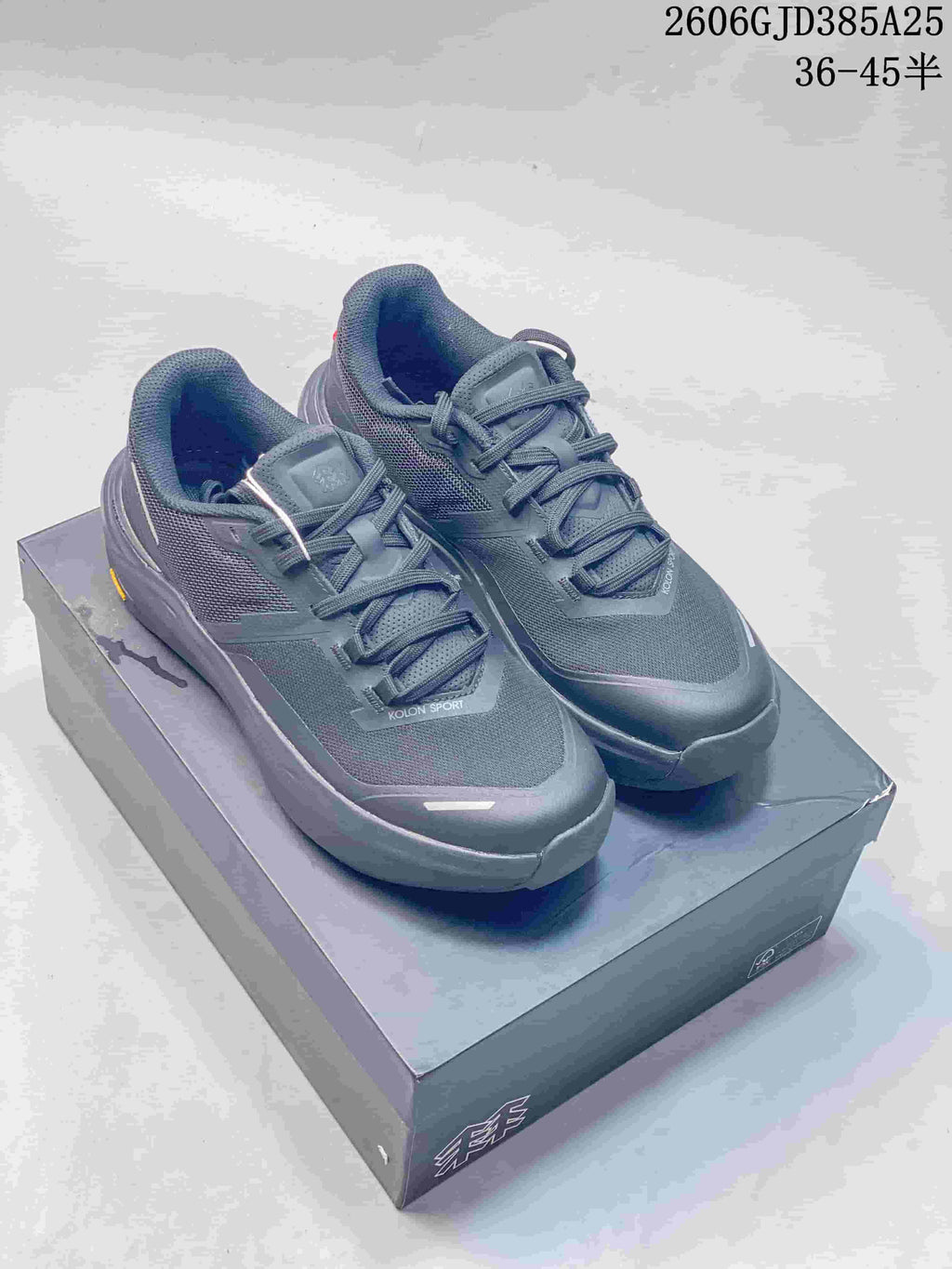 Dark gray and off-white Kolon Sport low-top shoes shown together
