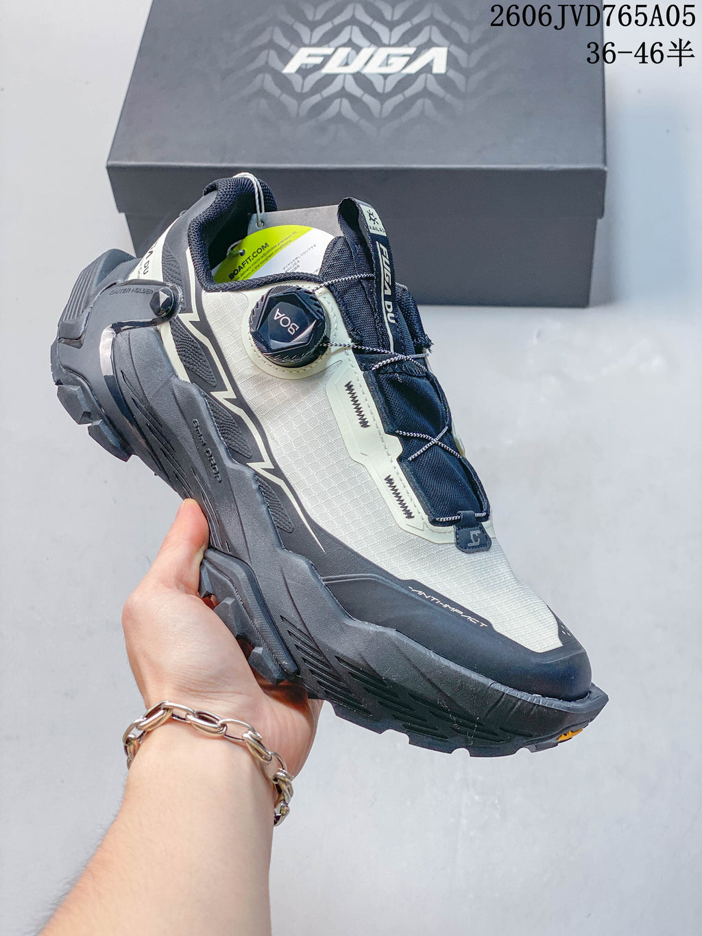 Angled side view highlighting the dial closure, protective overlays, and rugged sole.