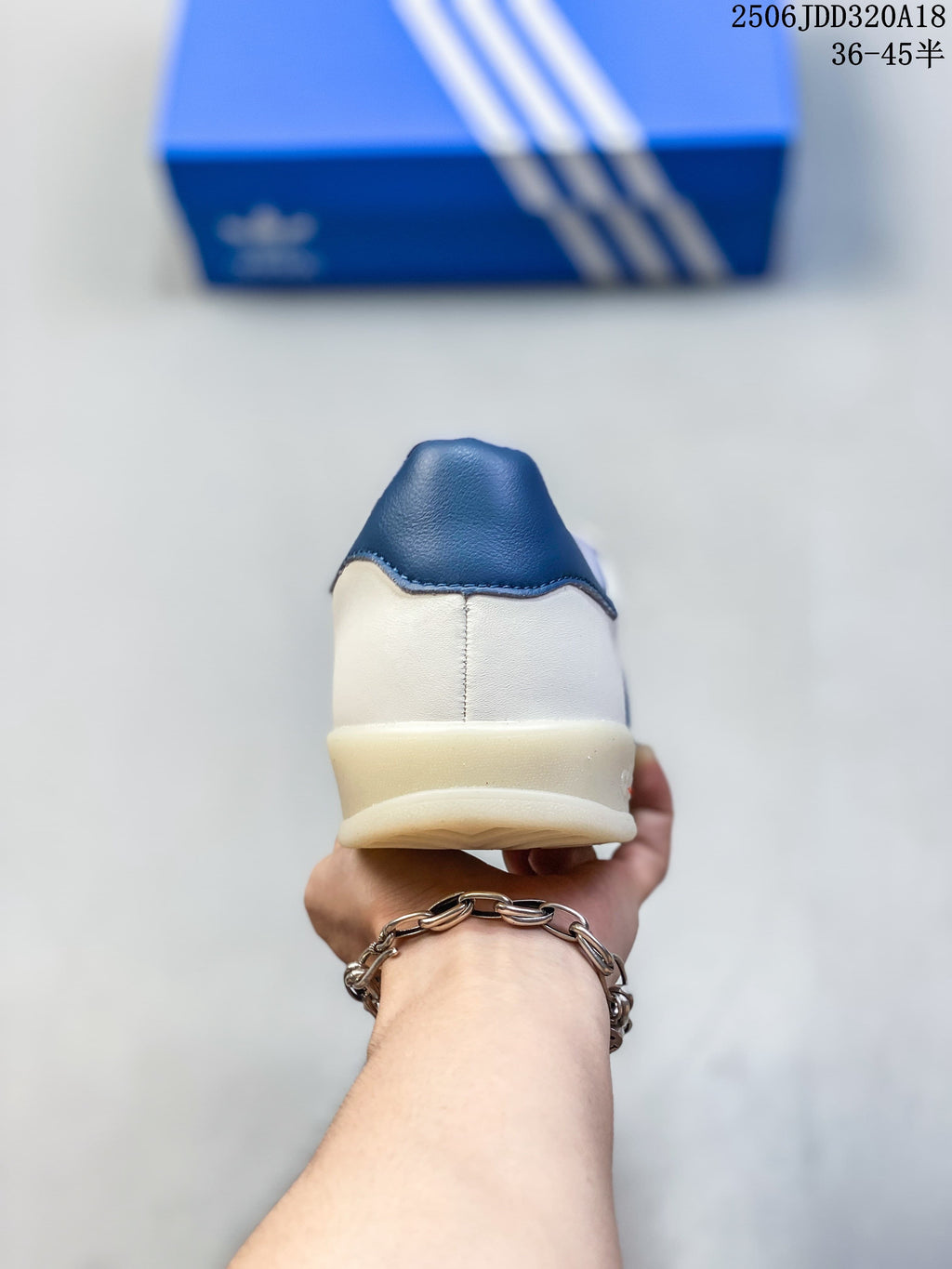 Rear view of the sneaker with a blue heel tab and light-colored sole.