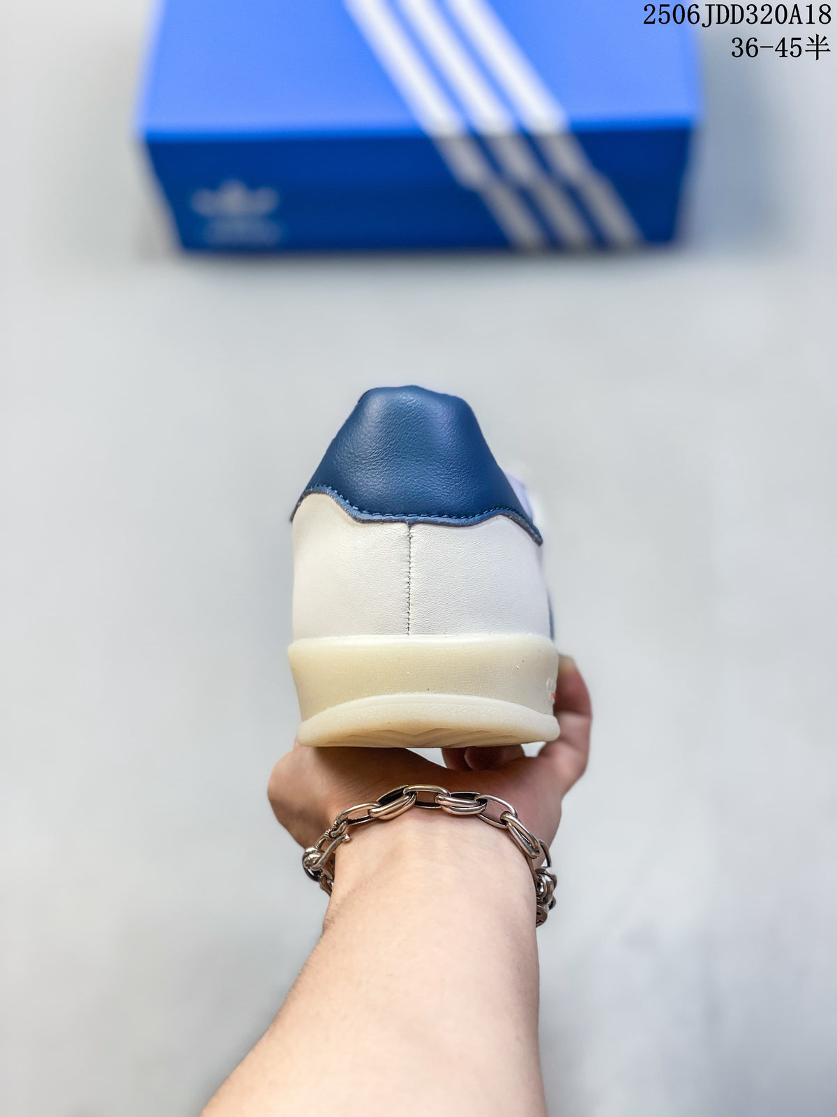 Rear view of the sneaker with a blue heel tab and light-colored sole.