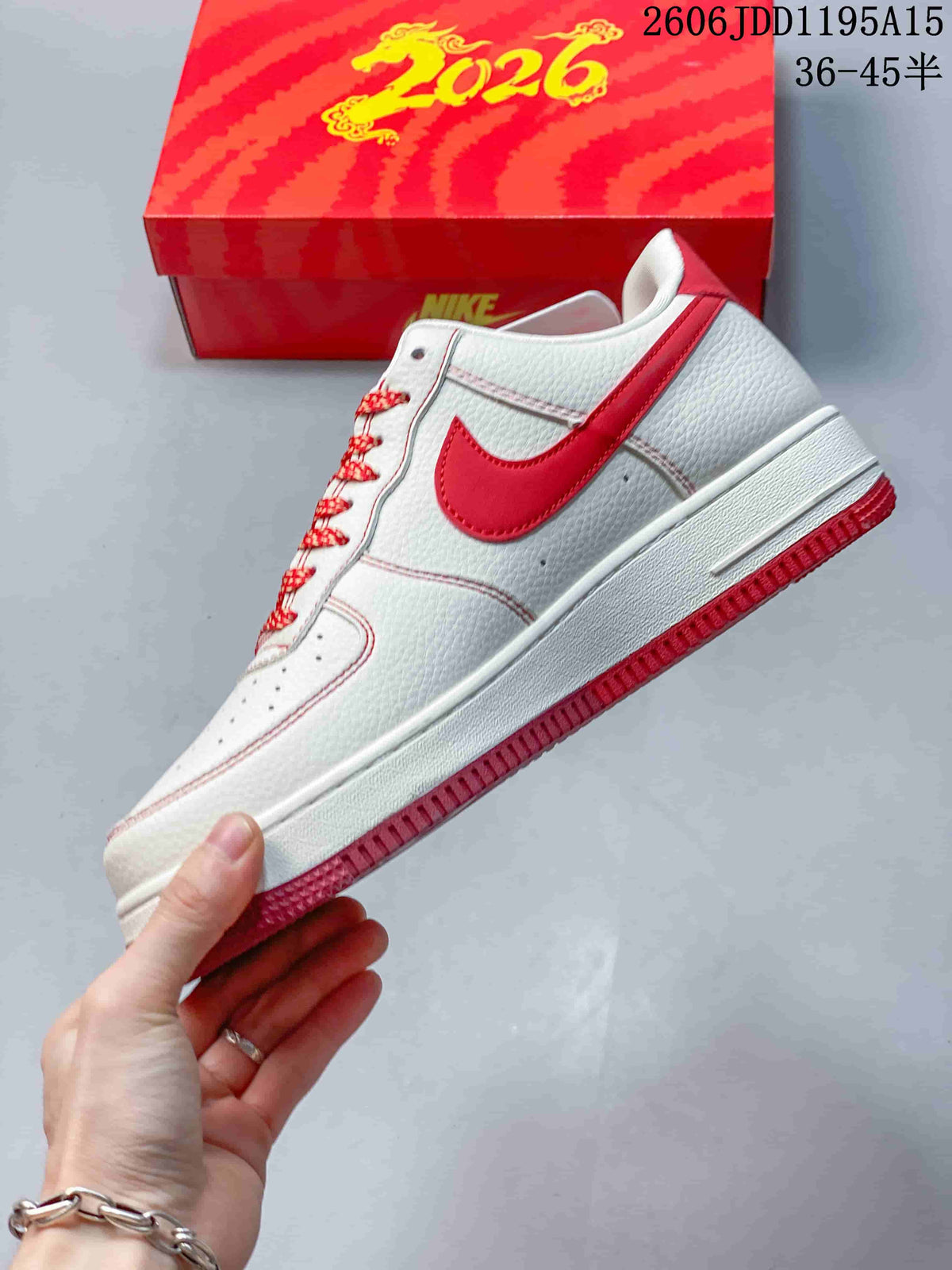 Side view of the white Nike Air Force 1 Low with red Swoosh and red outsole