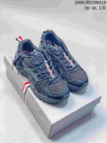 Pair of dark gray ASICS GT-2160 sneakers shown from above on a shoebox