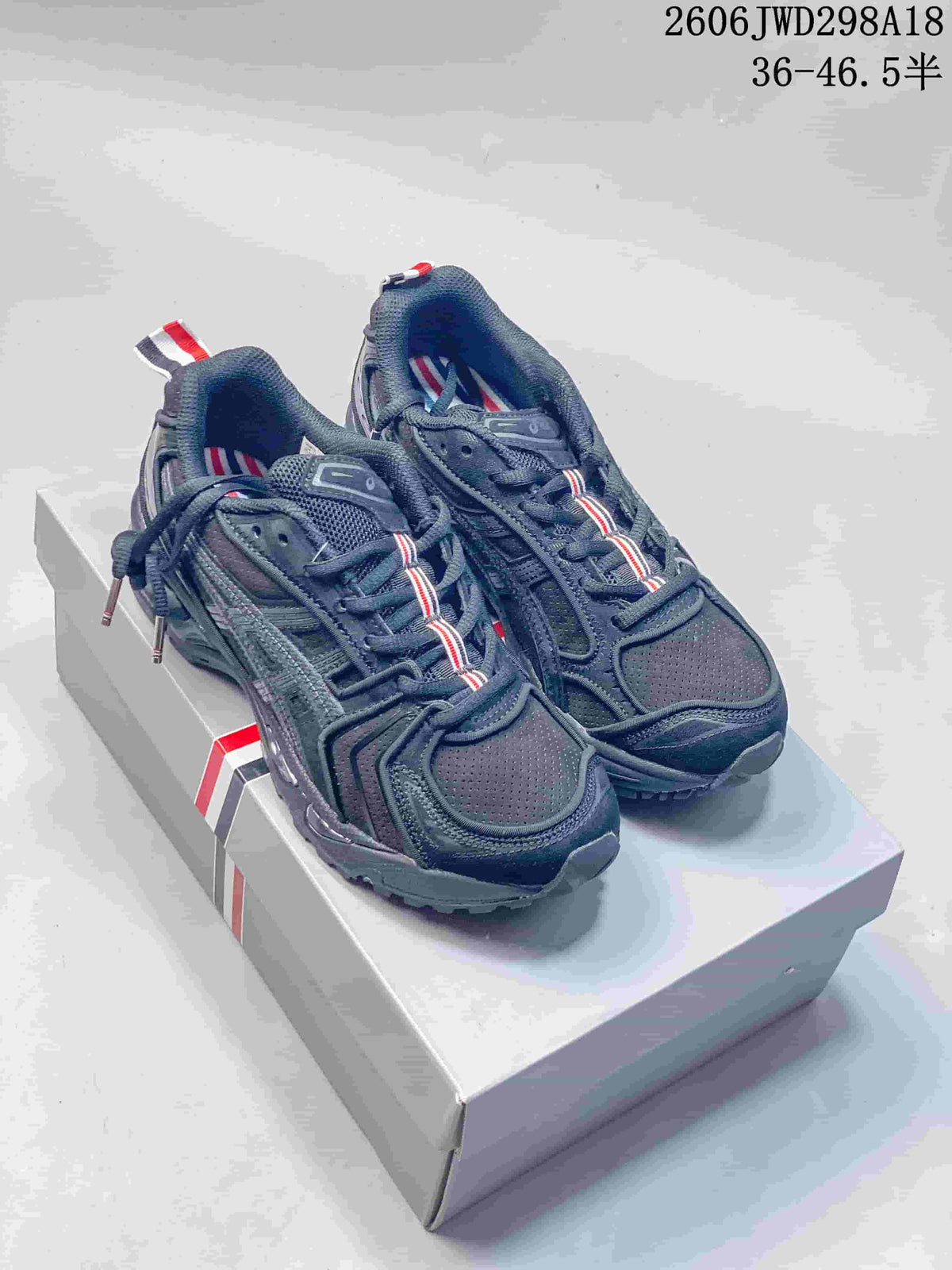 Pair of dark gray ASICS GT-2160 sneakers shown from above on a shoebox