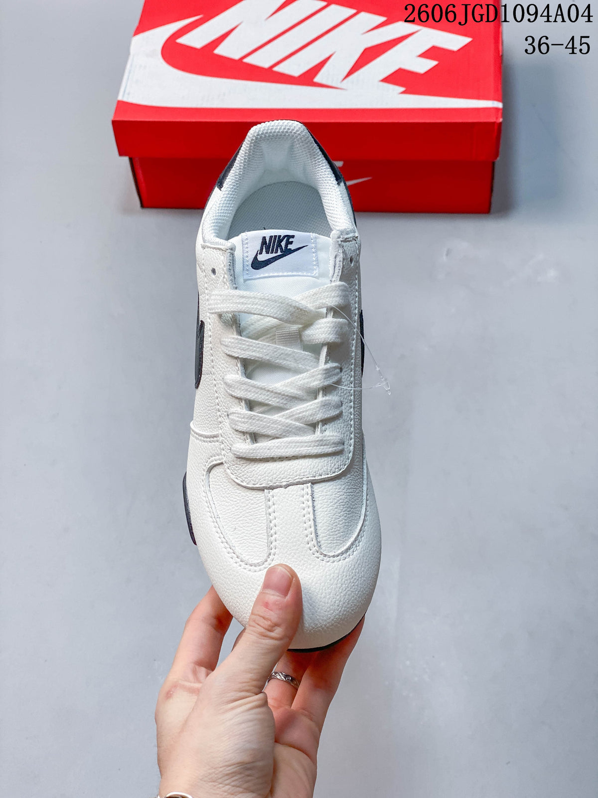 Top view of a white lace-up sneaker with a Nike tongue label