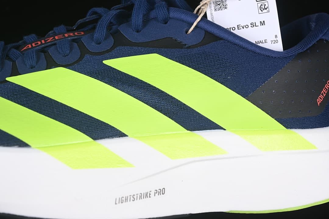 Close-up of lime side stripes and Lightstrike Pro marking on the white midsole.
