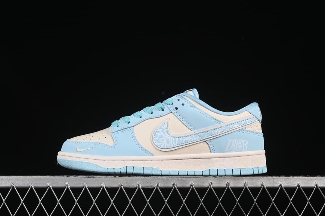 Side view of a pale blue and off-white Nike SB Dunk Low with teal laces and a patterned swoosh