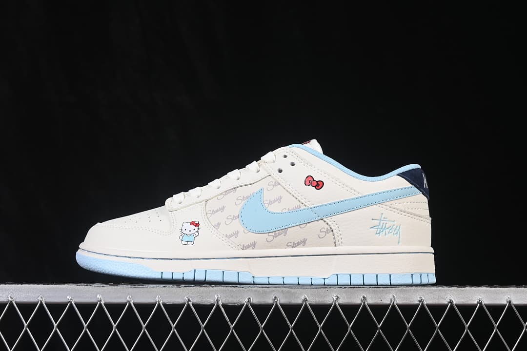 Side profile of an ivory and pale blue low-top sneaker with Hello Kitty graphics and a repeating script print.