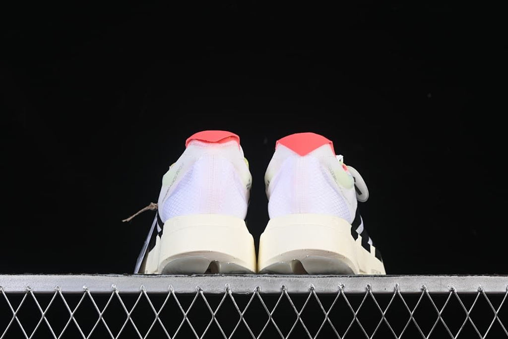 Rear view of both shoes highlighting the coral heel tabs and light-colored midsoles.