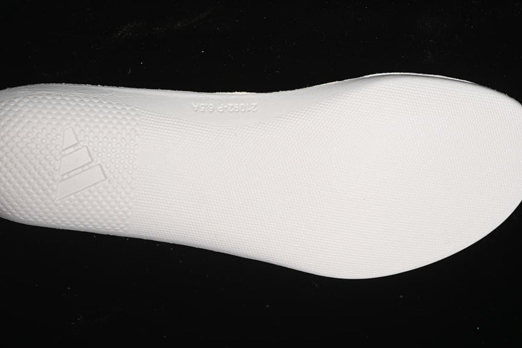 White textured outsole with raised Adidas logo
