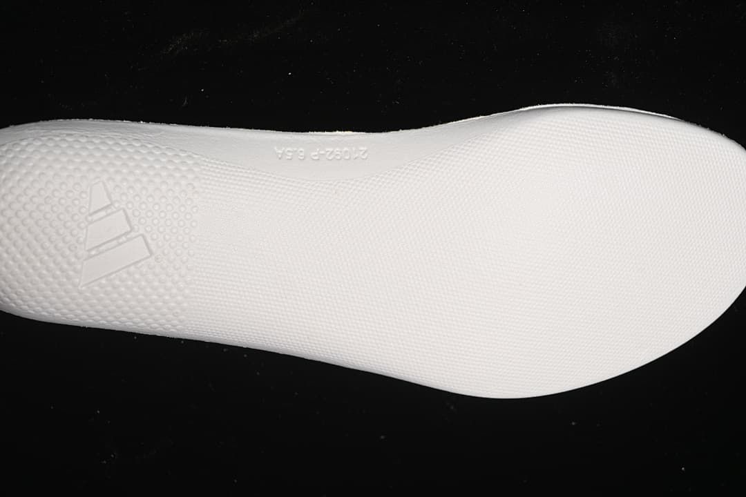 White textured outsole with raised Adidas logo
