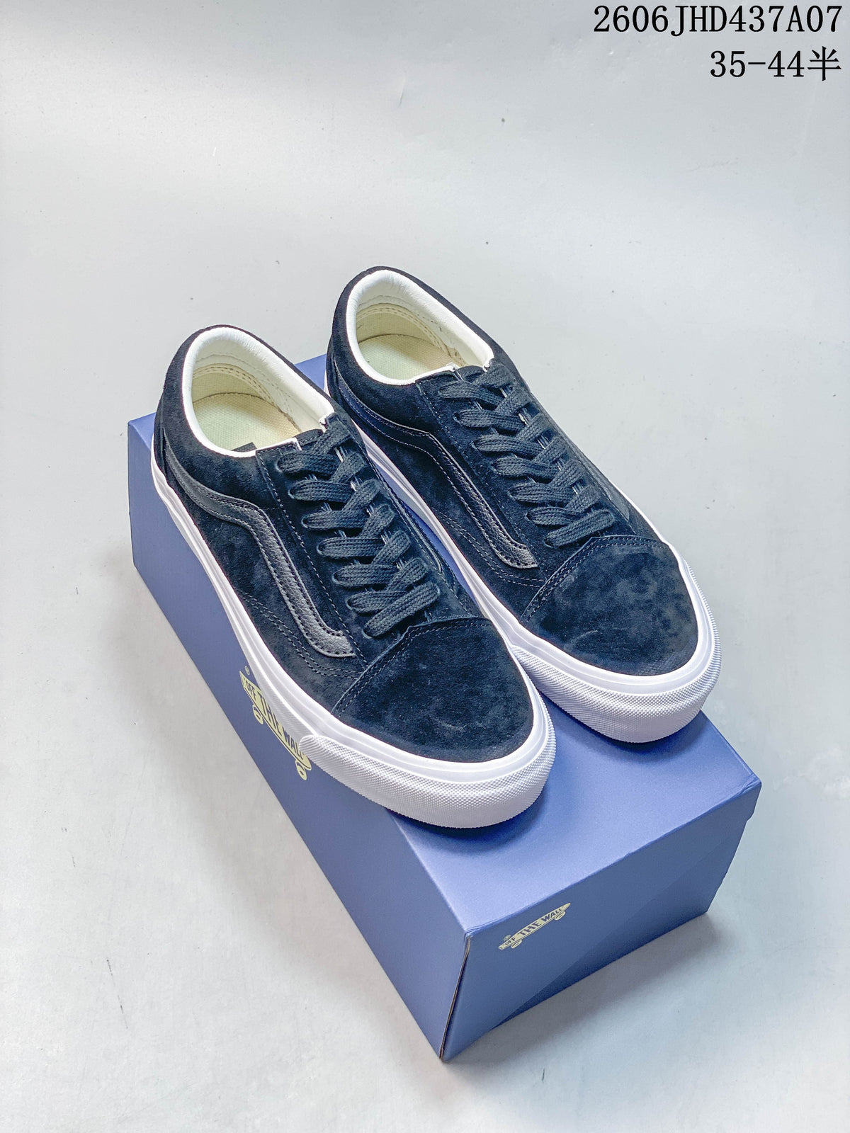 Pair of dark navy Vans Old Skool 36 low-top sneakers with white side stripes and white outsoles, shown on a blue Vans box.