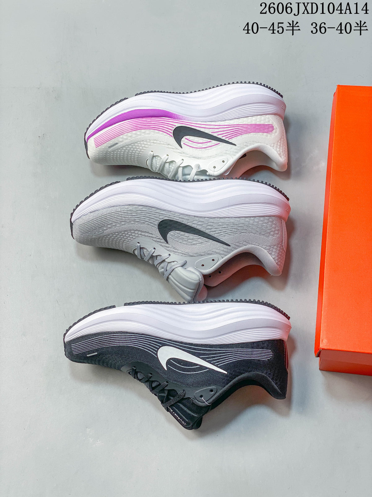 Three Nike Journey Run shoes shown from the side in white with purple accents, light gray, and dark gray.