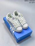 Pair of pale blue and off-white Adidas Superstar low-top sneakers displayed on a blue shoe box